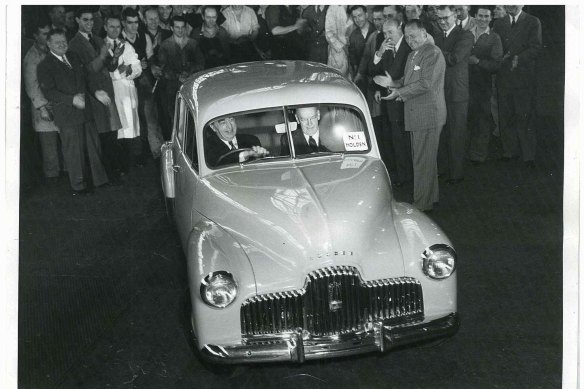 Harold Bettle, then managing director of GMH, drives the first production Holden off the assembly line in Fishermans Bend.