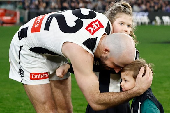 Steele Sidebottom of the Magpies is seen with children Ned and Matilda after his final match.
