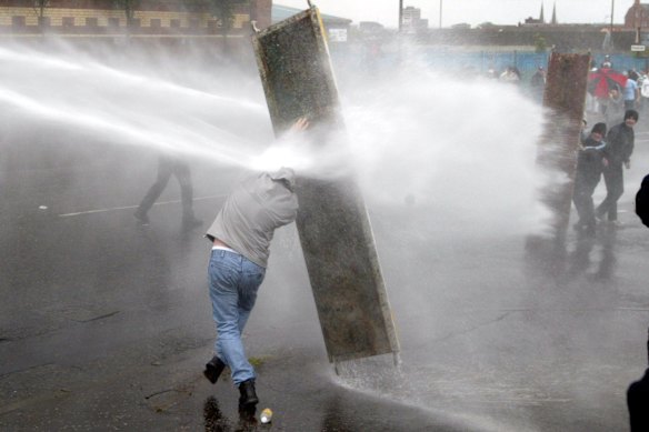 A water cannon is used in a riot in West Belfast, Northern Ireland in 2002.