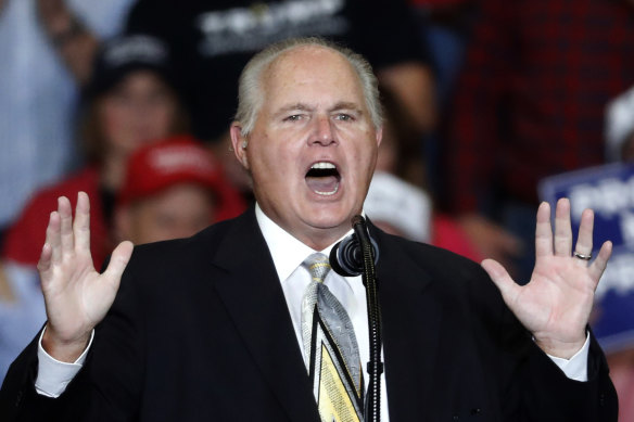 Rush Limbaugh, pictured at a rally for Donald Trump in 2018, has died. 