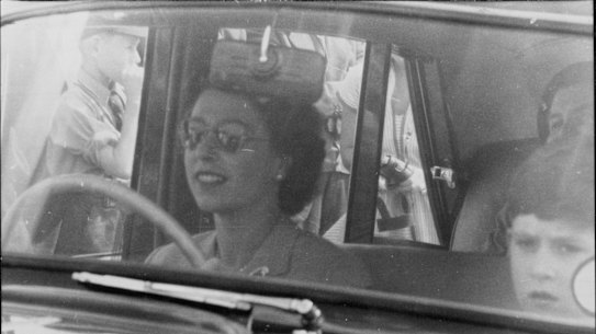 The Queen drives her children to a polo game at Windsor Great Park in 1956. Prince Charles is sitting beside her.