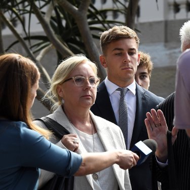 A lawyer for Callan Sinclair fends off reporters after the jury was discharged on Monday.