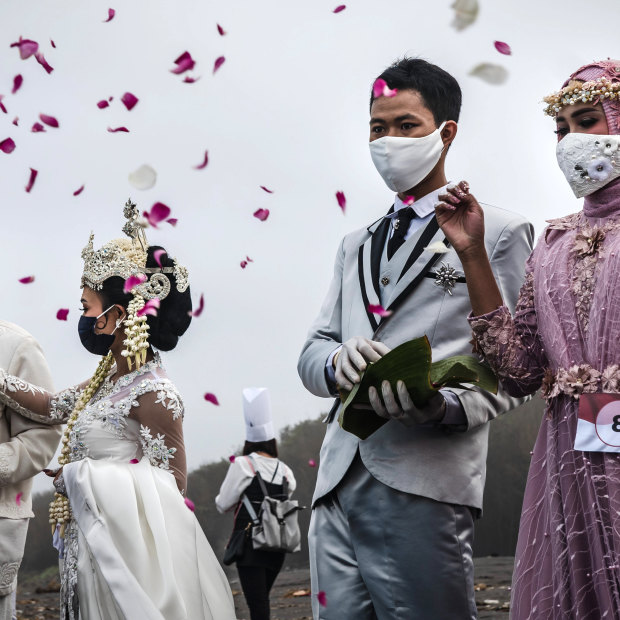 Couples sow flowers as they  attend a mass wedding during the pandemic in Yogyakarta.