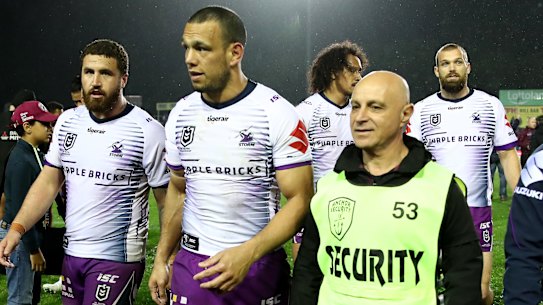 Security detail: Will Chambers is escorted from the field following the Manly-Storm match at Lottoland.