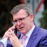 Stood-aside minister Alan Tudge tight-lipped as he attends citizenship ceremony