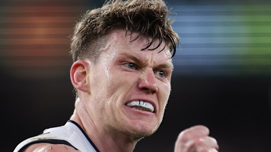 Sam Walsh flashes his “Dior” mouthguard after kicking a goal against the Demons.