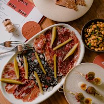 Charcuterie plate, raw beef with rhubarb and buckwheat, olives, charred lupini, and basturma, pickled chilli.