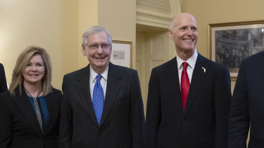 Florida's Rick Scott (right) arrived for the first day of the new Congress on Wednesday despite the result not being finalised yet.