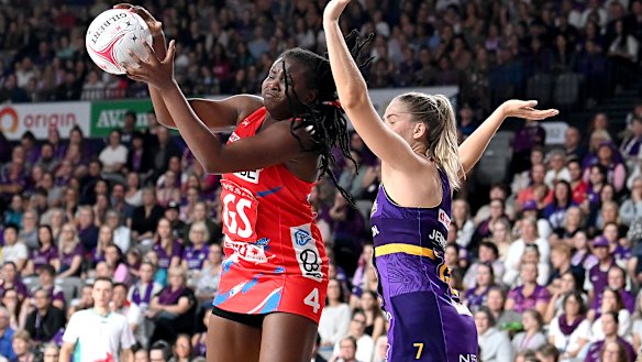 NSW’s Sam Wallace holds off Kim Jenner to take a pass.