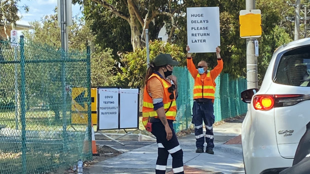 Signs at a Heidelberg testing site telling people to return later.