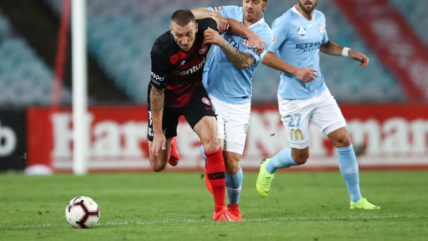 On the ball: Western Sydney's Mitchell Duke competes with City's Luke Brattan.