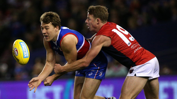Best of the best: Bulldog Jack Macrae gets tackled by Mitch Hannan of the Demons.
