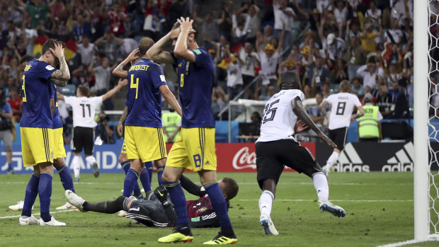 Devastated: Sweden players react after Toni Kroos' late winner.