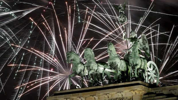 Fireworks light the sky above the Quadriga at the Brandenburg Gate.