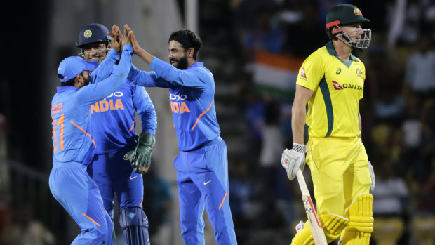 Shaun Marsh walks as India's Ravindra Jadeja (centre) celebrates during the second ODI.
