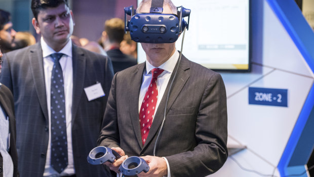 Minister for Communications, Cyber Safety and the Arts Paul Fletcher tries out Entertainment Experience Platform (IEEP) with immersive 360-degree, real-time VR broadcast at the Infosys Melbourne launch of the 5G Living Lab.