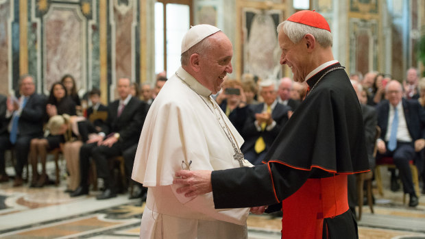 Pope Francis, left, talks with  Cardinal Donald Wuerl, during a visit to the Vatican.