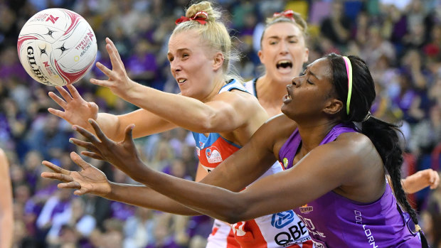 Maddy Turner battles with Romelda Aiken of the Firebirds during their tough Super Netball encounter.
