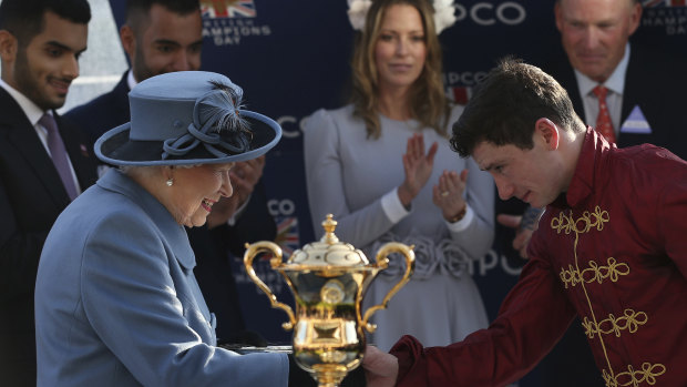 Queen Elizabeth II presents Oisin Murphy with his trophy after Roaring Lion won The Queen Elizabeth II Stakes Race at Ascot on October 20.