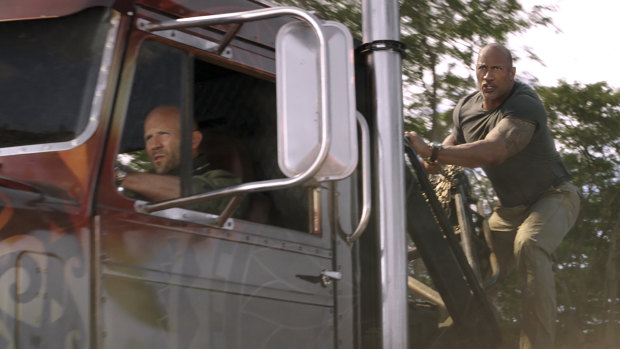 Jason Statham as Deckard Shaw (driving) and Dwayne Johnson as Luke Hobbs in the latest instalment of Fast & Furious.
