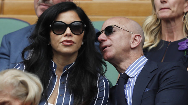 Jeff Bezos with Lauren Sanchez at Wimbledon in July last year. Her brother is fighting the Amazon billionaire in court.