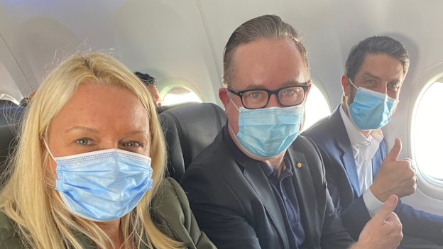 Happy with the middle seat in an early flight back in June: Qantas chief executive Alan Joyce, centre, with chief customer officer Steph Tully and Qantas International chief executive Tino La Spina.