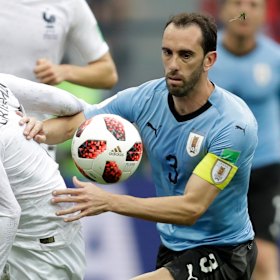 Uruguay's Diego Godin in action with France's Antoine Griezmann.