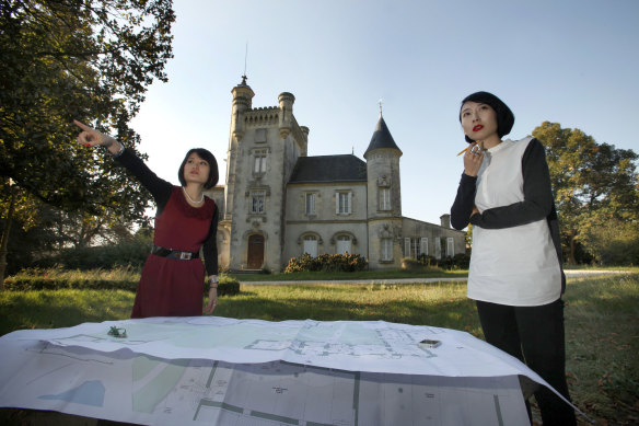 Elodie (left), manager of Chateau Latour-Laguens, in Bordeaux, France, with the plans for the property in 2013.