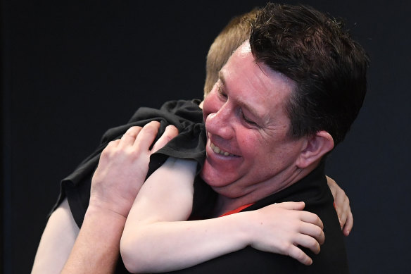 Brett Ratten hugs his youngest son Will after being announced as the new St Kilda coach.