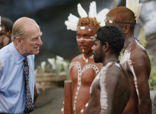 The Duke of Edinburgh talks to Aboriginal performers after watching a culture show at Tjapukai Aboriginal Culture Park, Cairns, 2002.