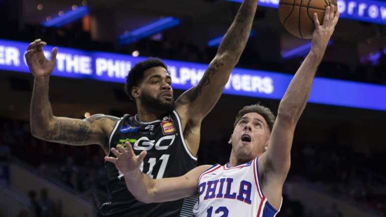 DJ Kennedy defends against Philadelphia 76er  T.J. McConnell.