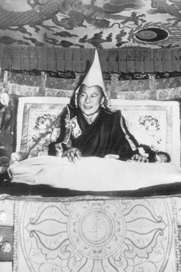 The Dalai Lama, aged 15, smiles from his throne in Lhasa in 1950. 