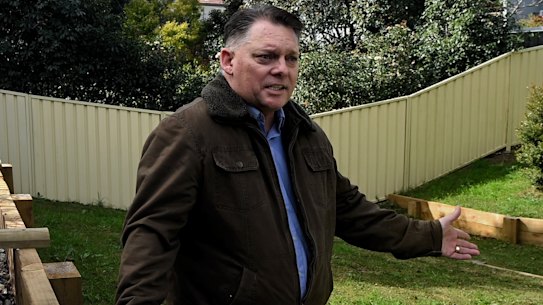 Scott Hinks in his backyard which was under approximately 4m of flood water. He has had to repair all the retaining walls. Windsor, NSW. July 21, 2023