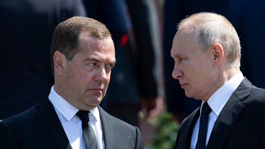 Russia’s former president Dimitry Medvedev speaks to Vladimir Putin.