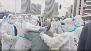 A resident is manhandled by police in Pudong New Area, Shanghai, the police was trying to remove them from their homes so that the buildings can be used as COVID19 quarantine site. 