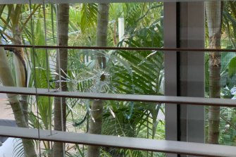 Bullet holes through the front window of Justis Huni’s house.