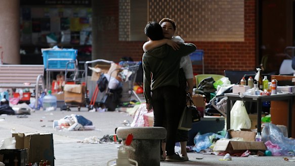 A protester hugs a social worker inside the campus of Hong Kong Polytechnic University in Hong Kong on Friday.