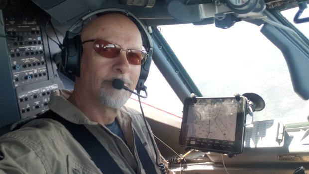 John Gallaher, a US pilot, at the controls of a Boeing 737 converted into an air tanker to fight fires for the NSW Rural Fire Service and other agencies.