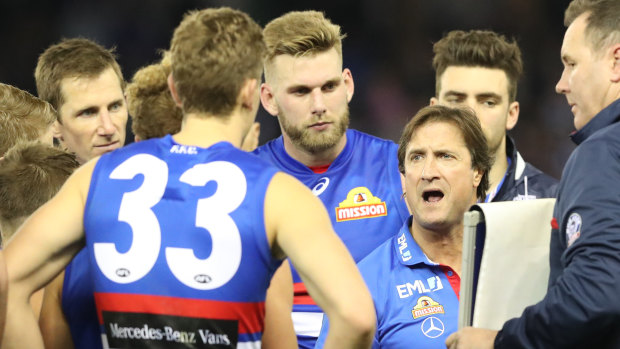 Barking out commands: Luke Beveridge with his players during the three-quarter time break.