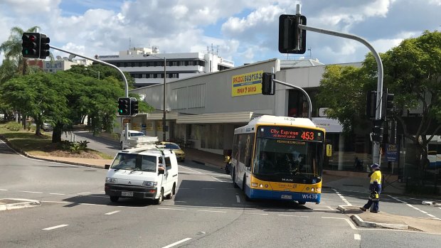 The intersection of High Street and Sherwood Road at Toowong. The proposed development includes the block behind the approaching bus.