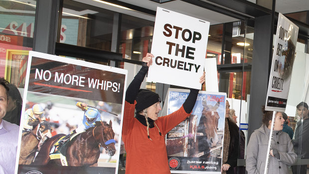 Anti-racing protesters rally outside the premier of the movie Ride Like a Girl.