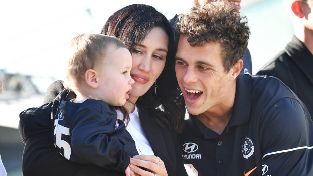 Curnow shares a moment with his wife and son.