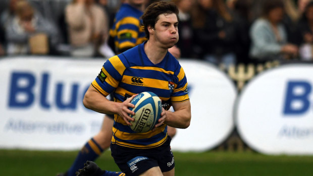 In the clear: Sydney University fullback Tim Clements runs the ball back against Manly.