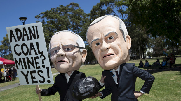 Anti-Adani coalmine protesters in Sydney donned bobble heads resembling Opposition Leader Bill Shorten and Prime Minister Scott Morrison to urge Labor to rule out matching the government's support for the mine.