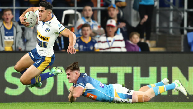 Dylan Brown skips through the tackle of AJ Brimson to score the first try for the Eels.