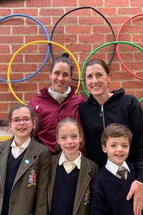 Laura Peel does the school pick-up with Winter Olympics great Jacqui Cooper after arriving home from her world championship win last year. The children are (from left) Madeline, Grace, Thomas.