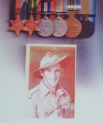 A photo of Raymond Tomkins and his World War II medals.