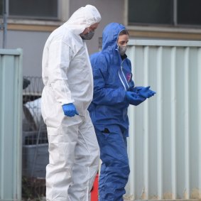Forensic police examine a home in Lalor Park after a girl was shot dead.