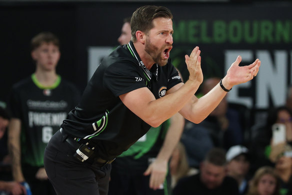South East Melbourne Phoenix coach Josh King urges his players on.