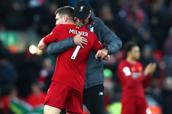 Safe: Liverpool manager Jurgen Klopp embraces James Milner after thumping Everton this week. 